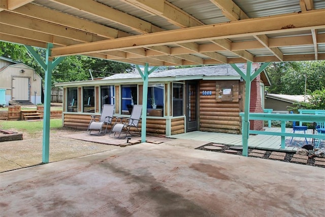 21306 E 10th St, Hinton, OK 73047 - view of patio / terrace featuring a sunroom and a storage unit