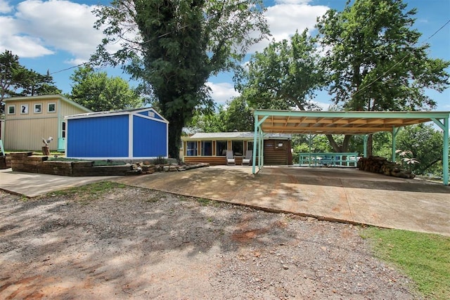 21306 E 10th St, Hinton, OK 73047 - view of yard featuring driveway, an outdoor structure, and a carport