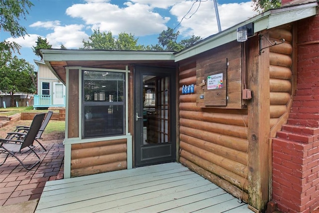 21306 E 10th St, Hinton, OK 73047 - entrance to property featuring log veneer siding and a patio area