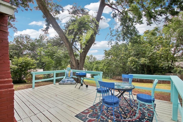 21306 E 10th St, Hinton, OK 73047 - wooden deck featuring a grill, view of scattered trees, and outdoor dining space