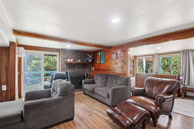 21306 E 10th St, Hinton, OK 73047 - living room featuring light wood finished floors, beam ceiling, and wood walls