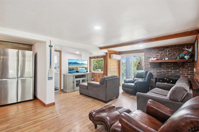 21306 E 10th St, Hinton, OK 73047 - living area featuring light wood-style flooring, a brick fireplace, an AC wall unit, beamed ceiling, and recessed lighting