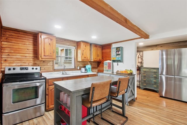 21306 E 10th St, Hinton, OK 73047 - kitchen featuring appliances with stainless steel finishes, light wood-type flooring, a kitchen island, beam ceiling, and recessed lighting