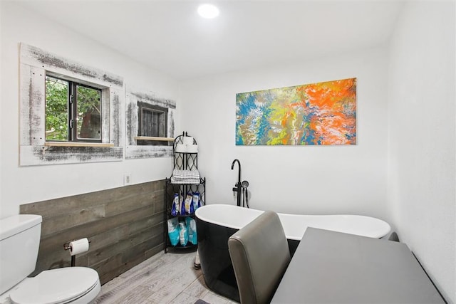 21306 E 10th St, Hinton, OK 73047 - bathroom featuring a freestanding bath and wood finished floors