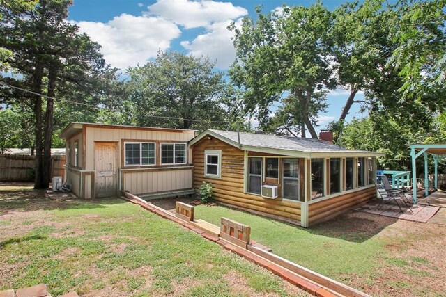 21306 E 10th St, Hinton, OK 73047 - back of house with a chimney, a sunroom, and an outbuilding