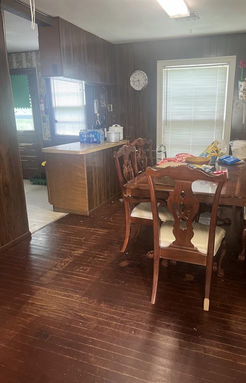 3009 NW 43rd St, Oklahoma City, OK 73112 - dining room featuring hardwood / wood-style flooring and wood walls