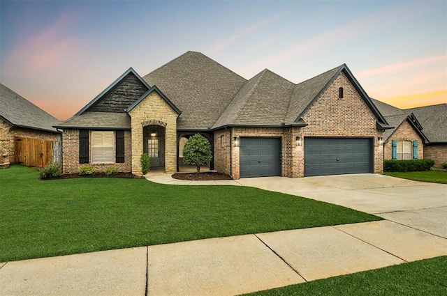 1108 Samantha Ln, Oklahoma City, OK 73160 - french country inspired facade with a garage, brick siding, concrete driveway, and roof with shingles