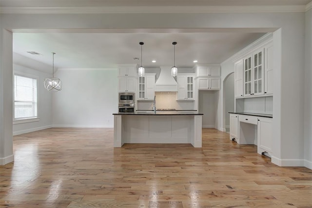 1108 Samantha Ln, Oklahoma City, OK 73160 - kitchen with appliances with stainless steel finishes, custom exhaust hood, dark countertops, baseboards, and light wood-style flooring
