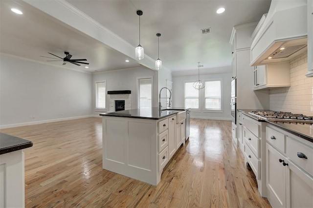1108 Samantha Ln, Oklahoma City, OK 73160 - kitchen featuring dark countertops, a sink, baseboards, ceiling fan, and white cabinetry