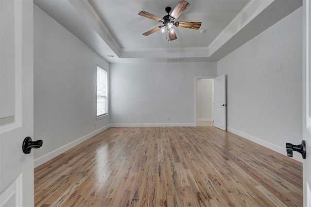 1108 Samantha Ln, Oklahoma City, OK 73160 - spare room featuring a tray ceiling, crown molding, light wood-type flooring, a ceiling fan, and baseboards