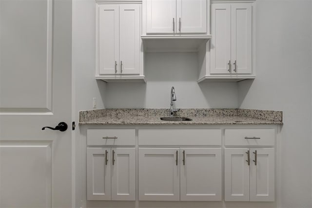 1108 Samantha Ln, Oklahoma City, OK 73160 - kitchen with a sink, white cabinets, and light stone countertops