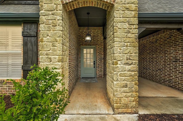 1108 Samantha Ln, Oklahoma City, OK 73160 - view of exterior entry featuring a shingled roof, brick siding, and stone siding