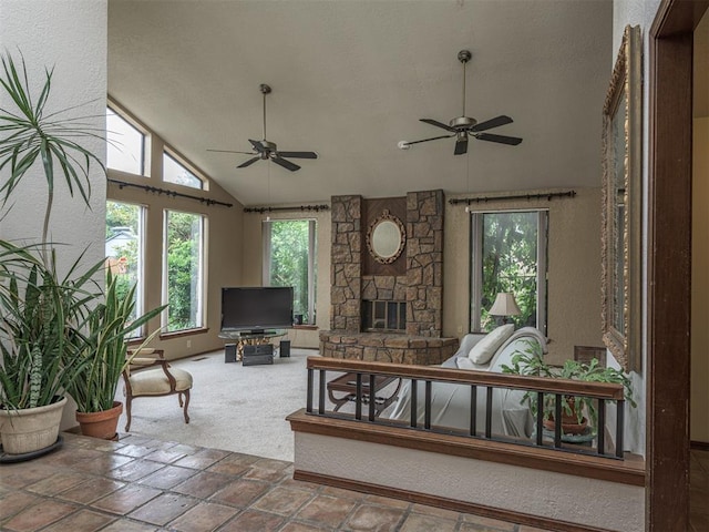 13501 Fox Hollow Rdg, Oklahoma City, OK 73131 - carpeted living room with a ceiling fan, vaulted ceiling, and a stone fireplace