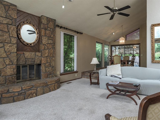 13501 Fox Hollow Rdg, Oklahoma City, OK 73131 - living room with carpet floors, lofted ceiling, ceiling fan, a stone fireplace, and baseboards