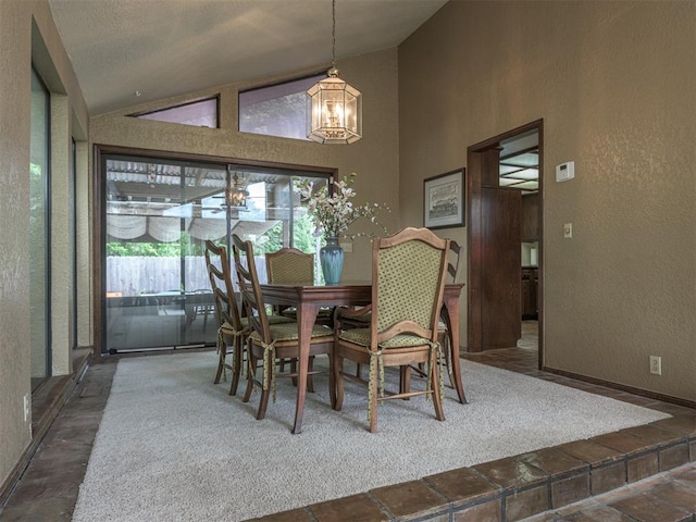 13501 Fox Hollow Rdg, Oklahoma City, OK 73131 - dining room featuring a chandelier, a textured wall, and high vaulted ceiling