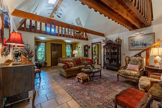 3824 Smoking Oaks Dr, Oklahoma City, OK 73150 - living area featuring beamed ceiling, stone tile flooring, ceiling fan, and high vaulted ceiling