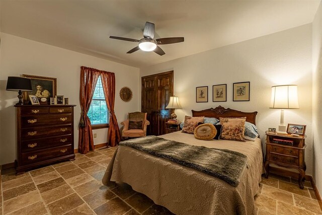 3824 Smoking Oaks Dr, Oklahoma City, OK 73150 - bedroom featuring stone tile floors, ceiling fan, and baseboards