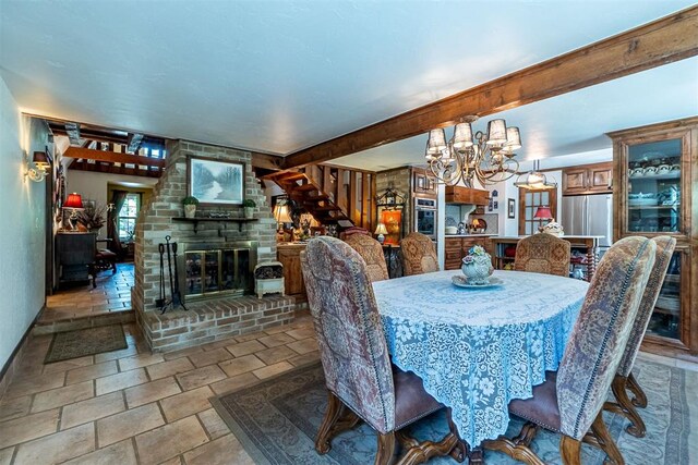 3824 Smoking Oaks Dr, Oklahoma City, OK 73150 - dining space with a chandelier, stone finish floors, a fireplace, baseboards, and beam ceiling