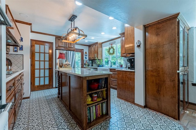 3824 Smoking Oaks Dr, Oklahoma City, OK 73150 - kitchen with light countertops, crown molding, baseboards, a center island, and recessed lighting