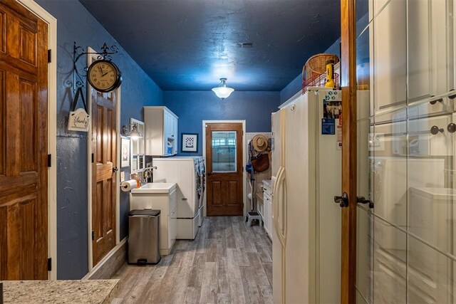 3824 Smoking Oaks Dr, Oklahoma City, OK 73150 - laundry area with light wood-type flooring, washer and clothes dryer, and wainscoting