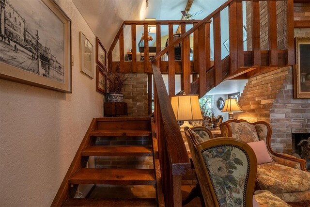 3824 Smoking Oaks Dr, Oklahoma City, OK 73150 - staircase with a textured wall and a fireplace