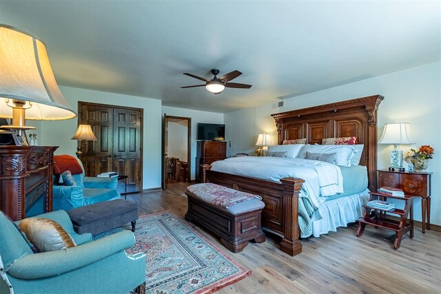 3824 Smoking Oaks Dr, Oklahoma City, OK 73150 - bedroom with light wood finished floors, ceiling fan, and baseboards