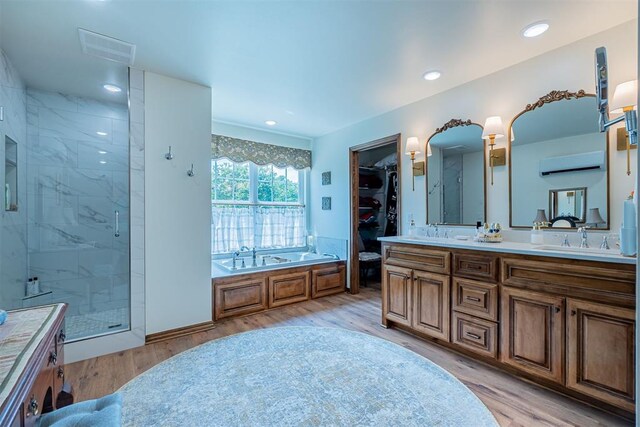 3824 Smoking Oaks Dr, Oklahoma City, OK 73150 - full bathroom with double vanity, wood finished floors, a shower stall, a bath, and recessed lighting