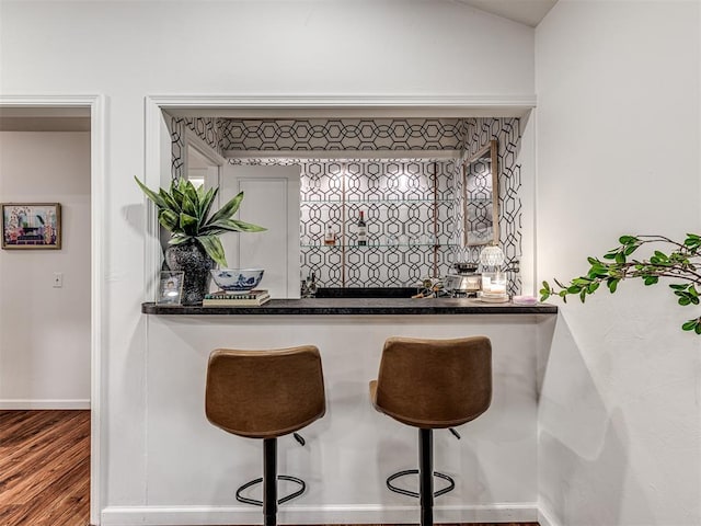 2009 Bella Vista Dr, Edmond, OK 73013 - indoor wet bar featuring baseboards and wood finished floors
