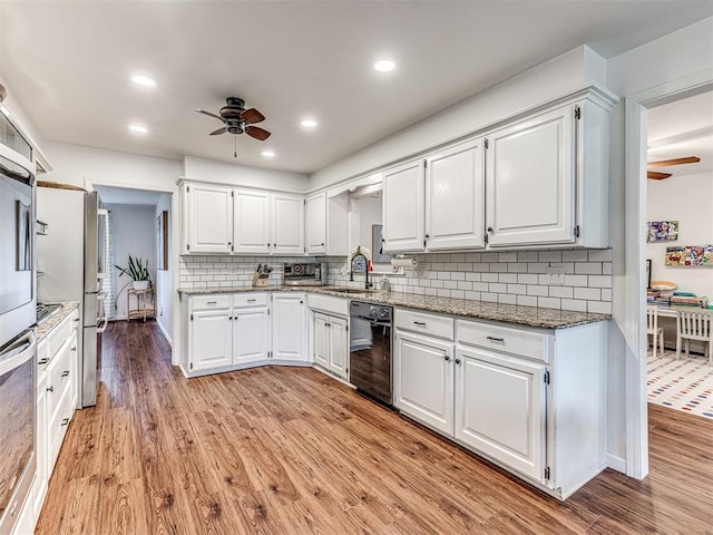 2009 Bella Vista Dr, Edmond, OK 73013 - kitchen featuring dishwasher, a ceiling fan, light wood finished floors, a sink, and white cabinetry