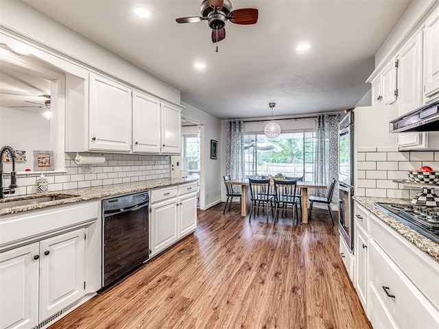2009 Bella Vista Dr, Edmond, OK 73013 - kitchen featuring black appliances, a ceiling fan, a sink, white cabinetry, and recessed lighting