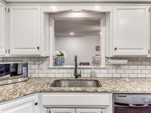 2009 Bella Vista Dr, Edmond, OK 73013 - kitchen with dishwasher, a sink, tasteful backsplash, and white cabinetry