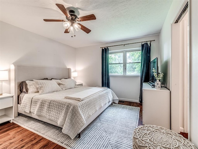 2009 Bella Vista Dr, Edmond, OK 73013 - bedroom featuring wood finished floors, a ceiling fan, and baseboards