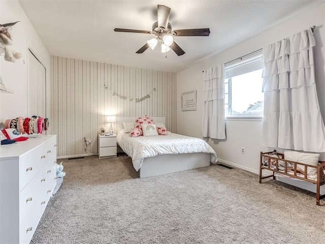 2009 Bella Vista Dr, Edmond, OK 73013 - bedroom with carpet floors, ceiling fan, baseboards, and wallpapered walls