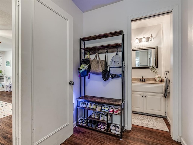 2009 Bella Vista Dr, Edmond, OK 73013 - hallway with dark wood finished floors, a sink, and baseboards