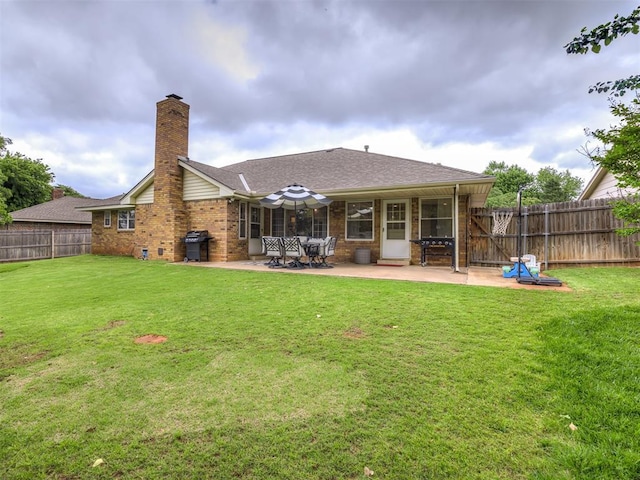 2009 Bella Vista Dr, Edmond, OK 73013 - rear view of property featuring a patio, brick siding, a chimney, and a shingled roof