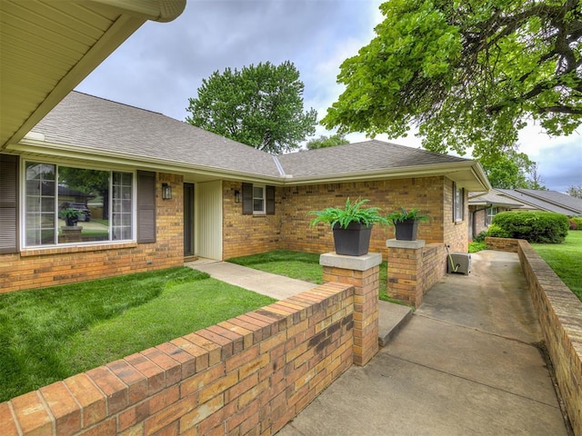 2009 Bella Vista Dr, Edmond, OK 73013 - view of front of property with brick siding, a front yard, and roof with shingles