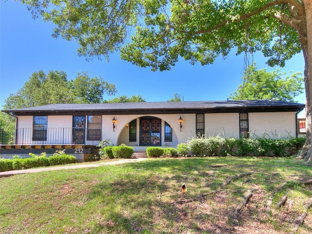 212 W Ridgewood Dr, Midwest City, OK 73130 - ranch-style house with a front lawn and brick siding