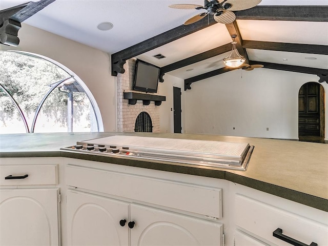 212 W Ridgewood Dr, Midwest City, OK 73130 - kitchen featuring ceiling fan, white cabinets, carpet floors, and stainless steel cooktop