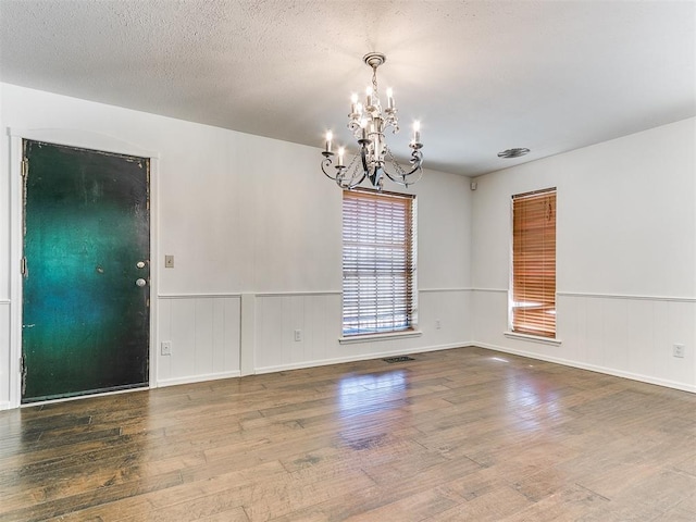 212 W Ridgewood Dr, Midwest City, OK 73130 - empty room featuring a chandelier, wood finished floors, and wainscoting