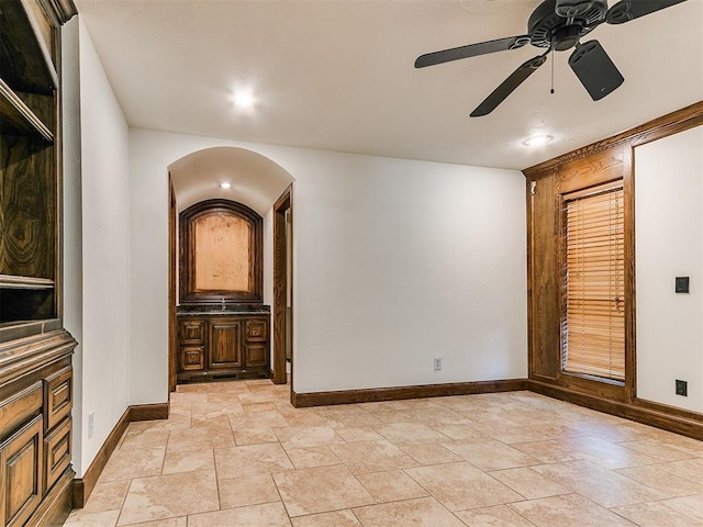 212 W Ridgewood Dr, Midwest City, OK 73130 - empty room with baseboards, ceiling fan, and stone tile floors