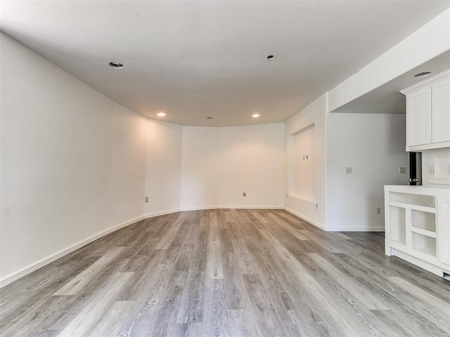212 W Ridgewood Dr, Midwest City, OK 73130 - unfurnished living room with light wood-style floors, baseboards, and recessed lighting