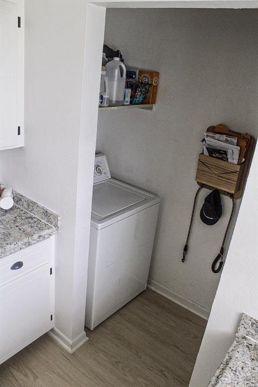 703 S 2nd Ave, Purcell, OK 73080 - laundry area with washer / dryer, light wood finished floors, and baseboards