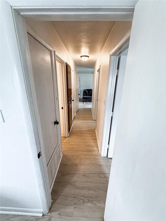 703 S 2nd Ave, Purcell, OK 73080 - hallway featuring light wood-style floors and baseboards