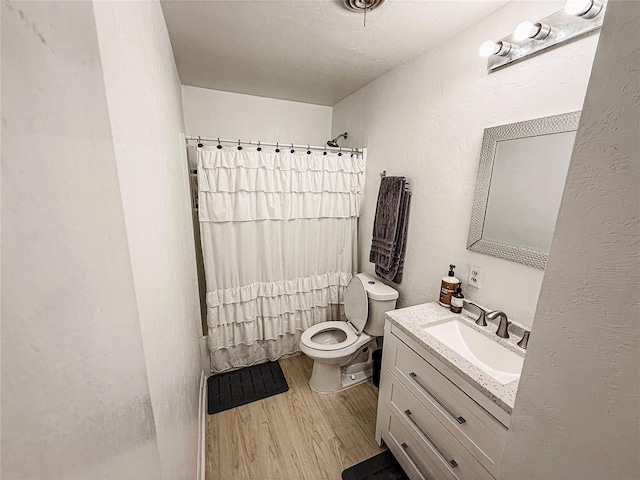 703 S 2nd Ave, Purcell, OK 73080 - full bath with vanity, wood finished floors, toilet, and curtained shower