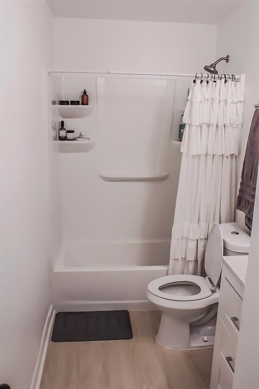 703 S 2nd Ave, Purcell, OK 73080 - bathroom with wood finished floors, toilet, vanity, and shower / bath combination with curtain