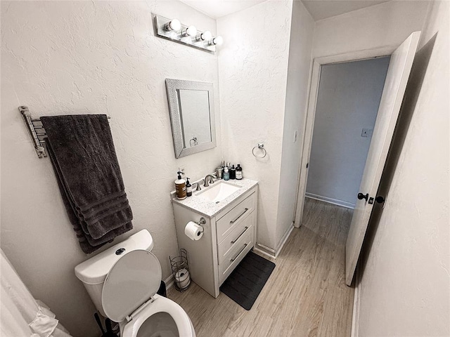 703 S 2nd Ave, Purcell, OK 73080 - bathroom featuring vanity, wood finished floors, and toilet