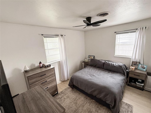 703 S 2nd Ave, Purcell, OK 73080 - bedroom featuring light wood-type flooring and a ceiling fan