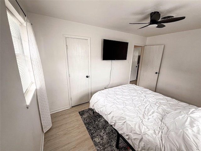 703 S 2nd Ave, Purcell, OK 73080 - bedroom with multiple windows, light wood-style flooring, baseboards, and a ceiling fan