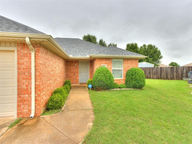 4537 SE 80th St, Del City, OK 73135 - doorway to property featuring a shingled roof, a garage, and brick siding