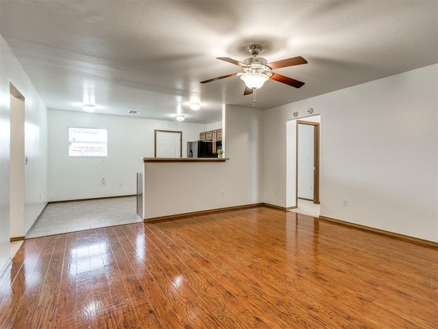 4537 SE 80th St, Del City, OK 73135 - unfurnished living room with wood finished floors, ceiling fan, and baseboards